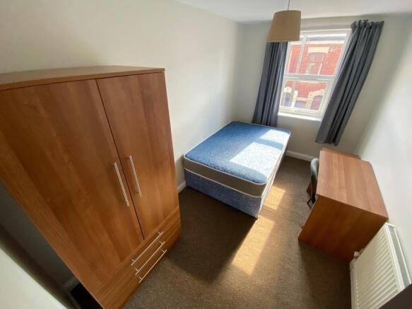 Spacious double bedroom featuring ample natural...