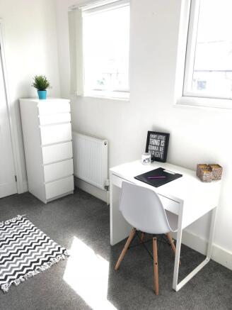 Bright and inviting communal workspace featurin...