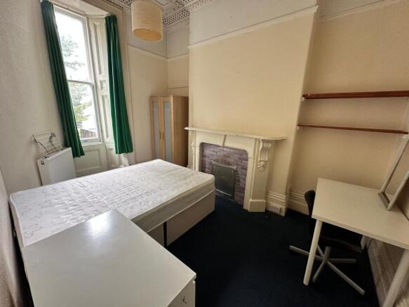 A bright and tidy double bedroom with ample spa...