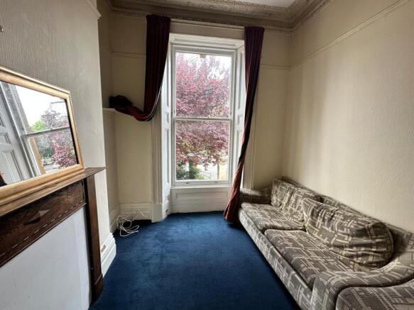 A bright and inviting living room featuring lar...