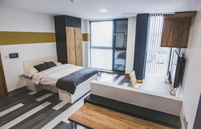 A modern and spacious master bedroom featuring ...