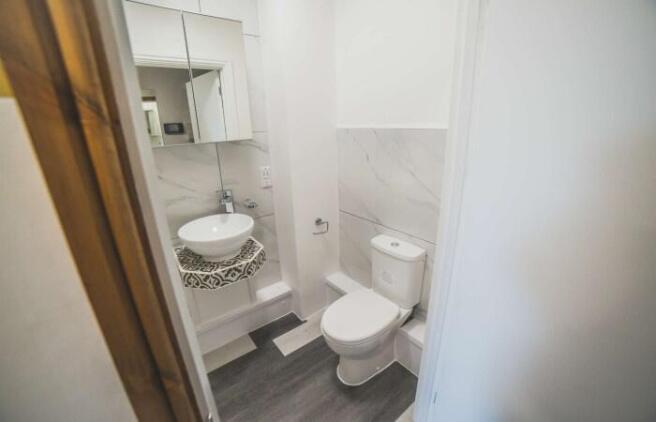 A modern and tidy single toilet room featuring ...