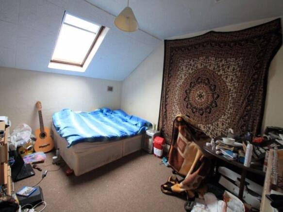 Bright and cozy bedroom featuring a comfortable...