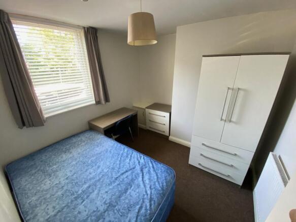 A bright and tidy double bedroom featuring a co...