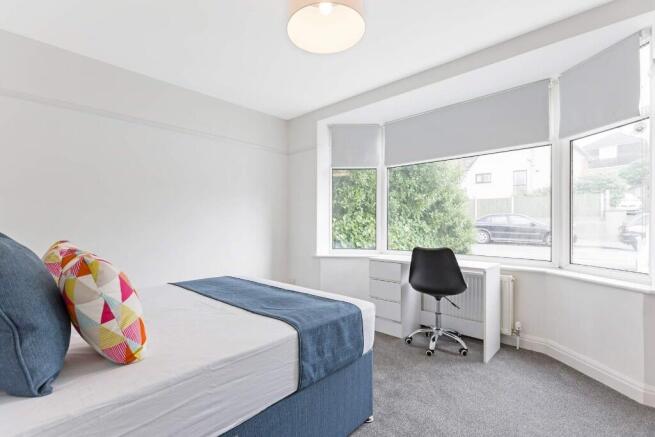 Bright and airy double bedroom featuring a comf...