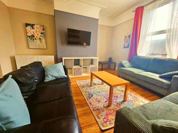 A spacious and welcoming living room featuring ...