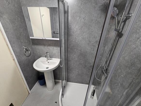 A modern bathroom suite featuring a shower encl...
