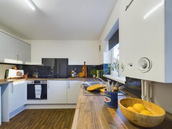 A modern and tidy kitchenette with ample storag...