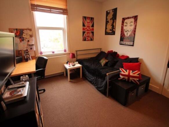 A cozy and well-maintained bedroom featuring a ...