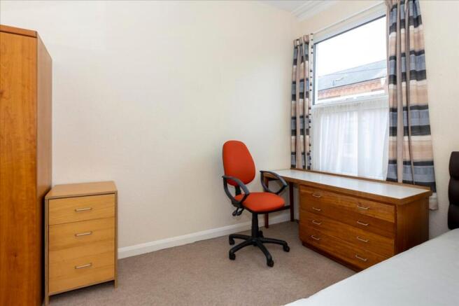 A bright and inviting double bedroom featuring ...