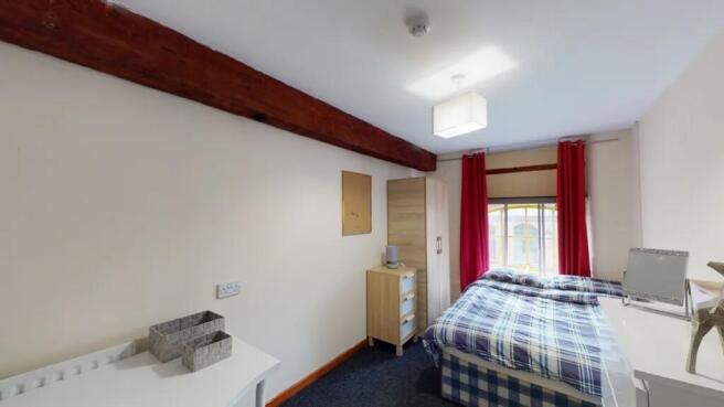 A bright and inviting double bedroom with moder...