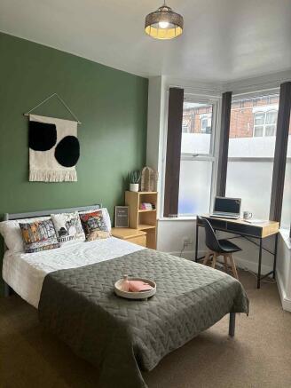 A stylish double bedroom featuring a cozy doubl...