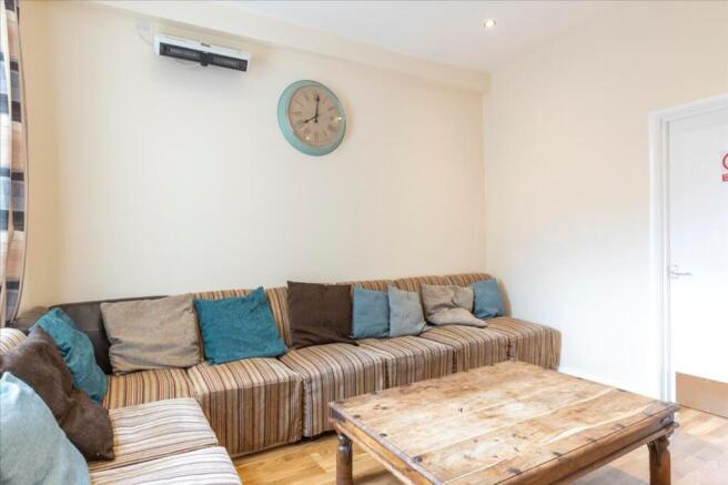 This cozy living room features a stylish stripe...