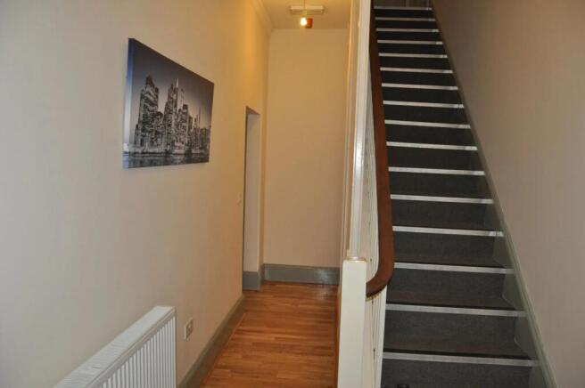A clean and well-maintained hallway featuring w...