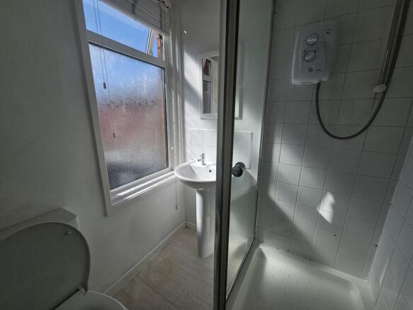 A clean and well-maintained bathroom with a sho...