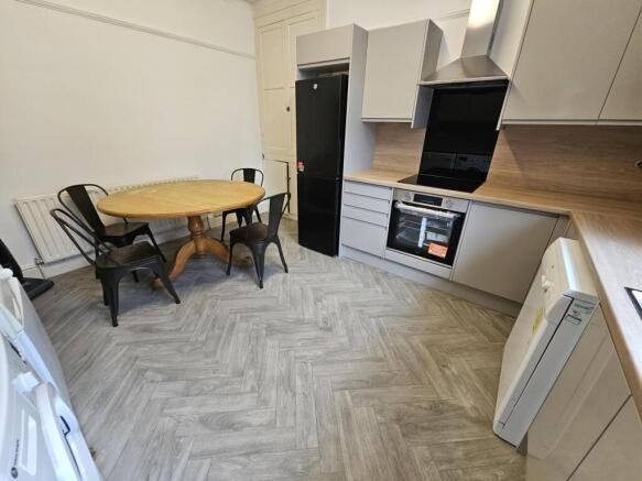 A modern kitchen with ample workspace, integrat...