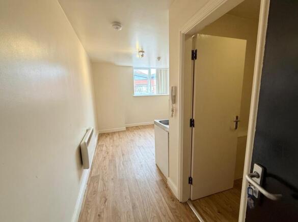 A clean and well-maintained hallway with wood-e...