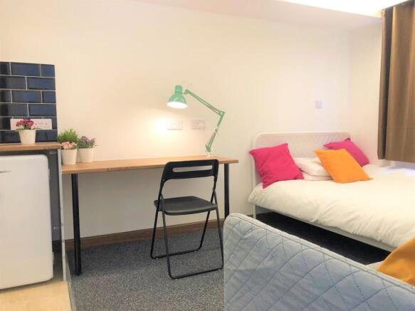 Bright and tidy single bedroom featuring a cozy...