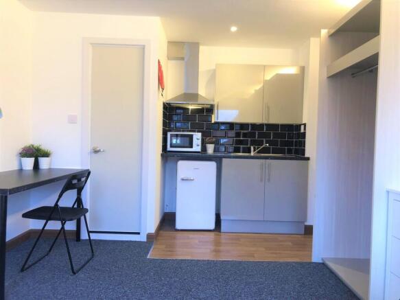 Bright and modern kitchenette featuring sleek c...