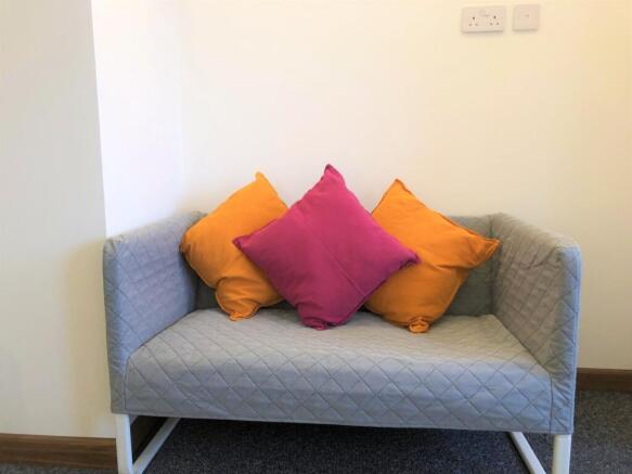 A cozy communal lounge area featuring a modern ...