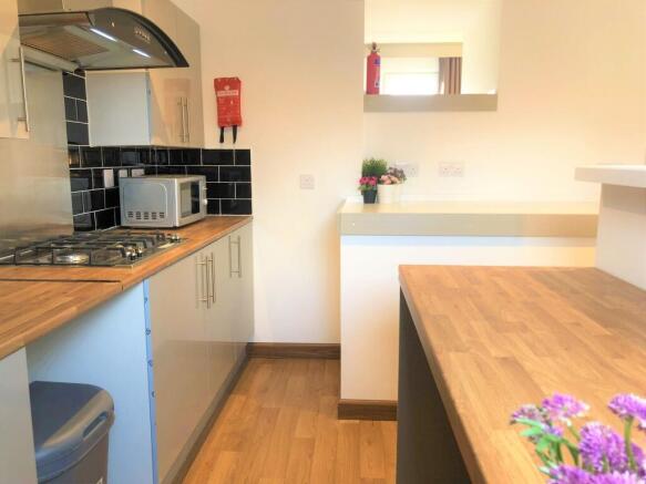 Bright and modern kitchen with wooden counterto...