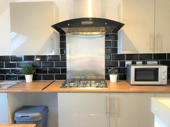 Modern kitchen area featuring a sleek gas hob w...