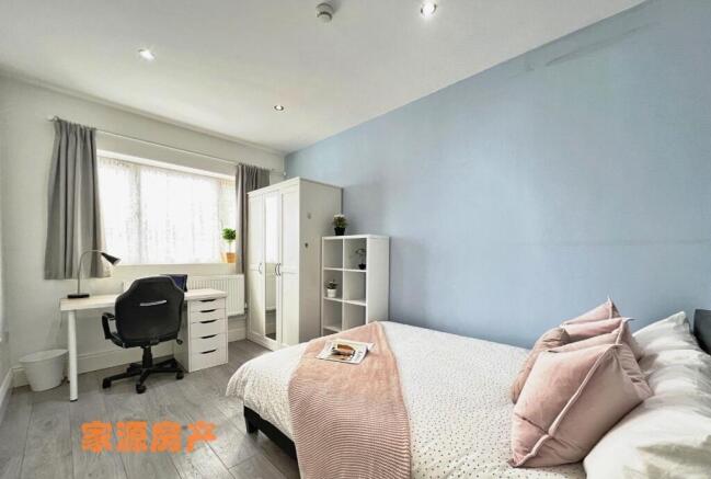 A bright and inviting double bedroom featuring ...