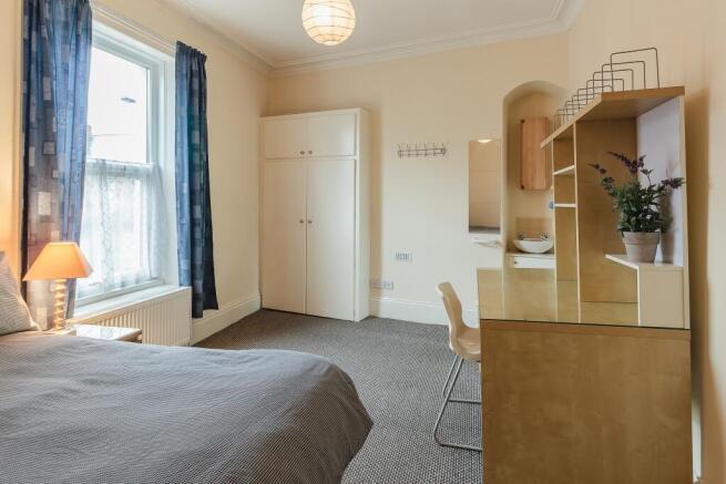 A bright and tidy double bedroom featuring a co...