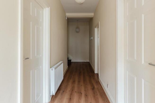A well-maintained hallway featuring clean woode...