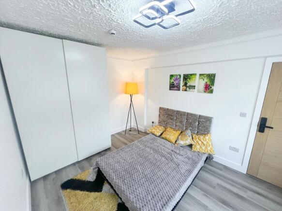 A modern double bedroom featuring a comfortable...