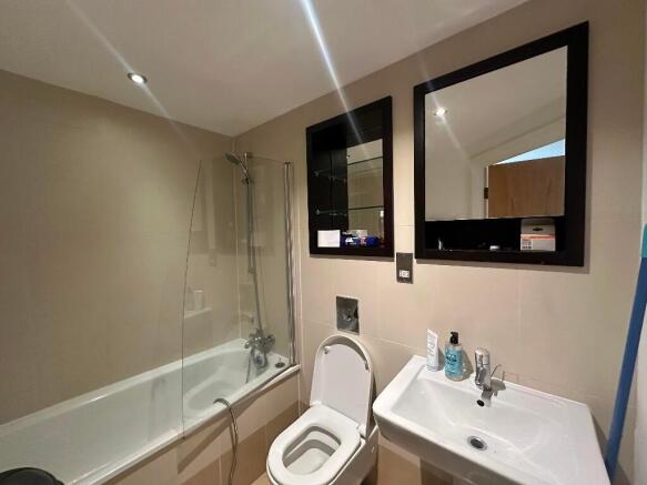Bright and modern bathroom suite featuring a ba...