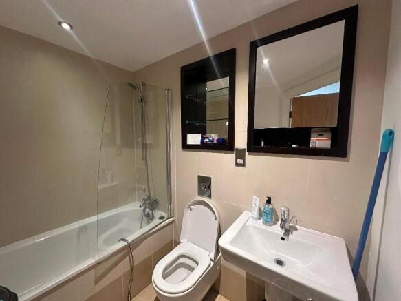 A modern bathroom suite featuring a clean white...