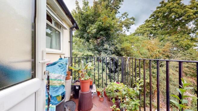 A charming balcony garden space featuring lush ...