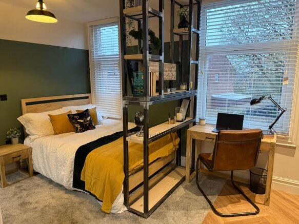 A spacious and stylish master bedroom featuring...