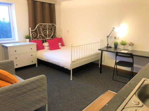 Bright and tidy double bedroom featuring a styl...