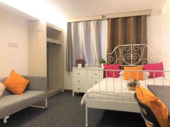 Bright and cozy double bedroom featuring a styl...