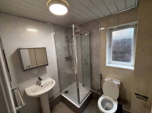 A clean and functional bathroom with a shower e...