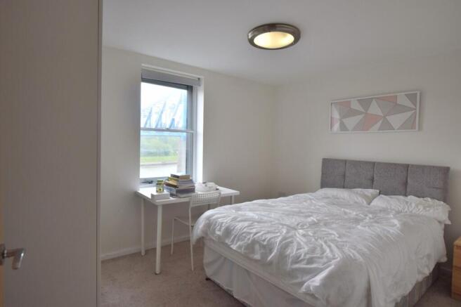 A bright and tidy double bedroom featuring a co...