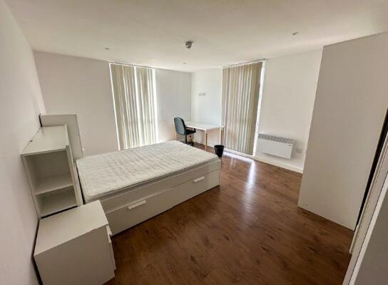 Bright and spacious master bedroom featuring a ...