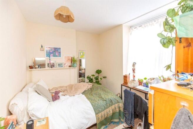 A cozy bedroom featuring a comfortable bed, a w...