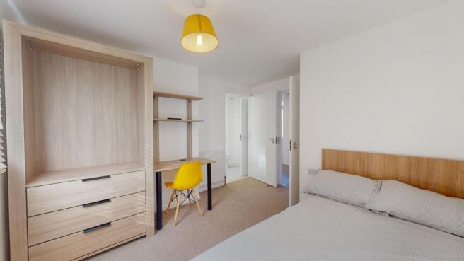 A bright and well-maintained master bedroom fea...
