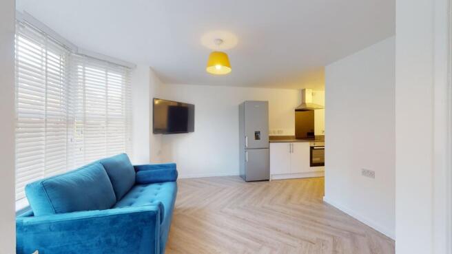 Bright and spacious living room featuring large...
