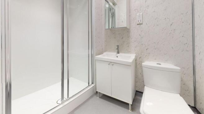 A modern, tidy bathroom featuring a shower encl...