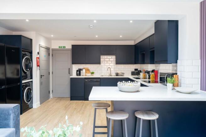 Modern and stylish kitchen with sleek dark cabi...