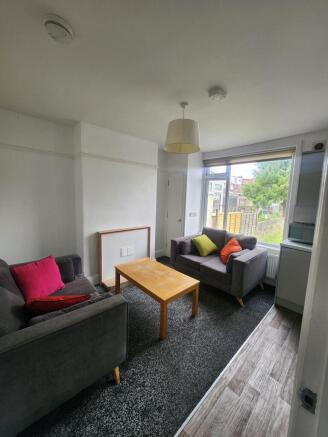 A cozy living room featuring two comfortable gr...