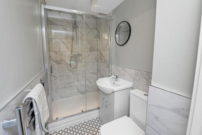 Modern bathroom featuring a spacious shower wit...