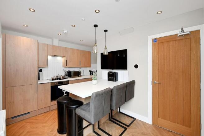Modern kitchen with sleek wooden cabinetry, a s...