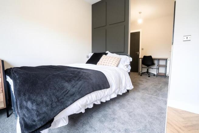 A bright, modern bedroom featuring a comfortabl...
