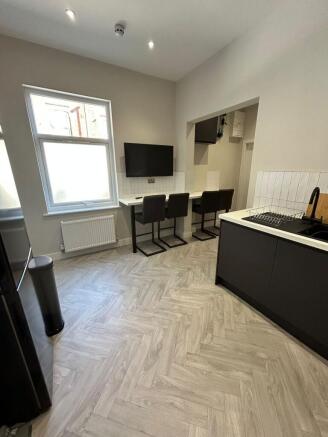 Modern kitchen area featuring a stylish black-a...