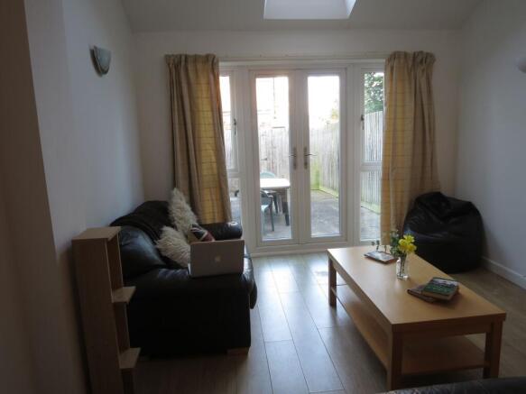 A welcoming living room filled with natural lig...